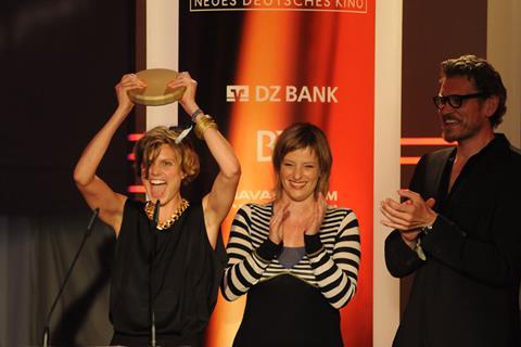 Hanna Doose in jubilation for winning Best Director prize at the German Cinema New Talent Award for Dust On Our Hearts, award with jurors Bettina Brokemper and Götz Otto